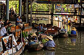 Thailand, Locals sell fruits, food and products at Damnoen Saduak floating market near Bangkok 